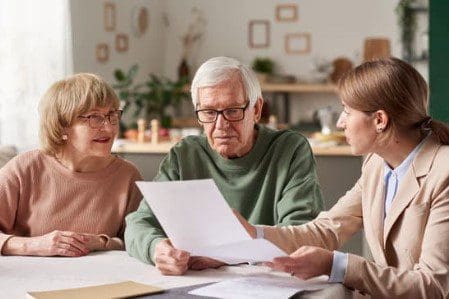 make a will month people looking at paperwork - make a will month
